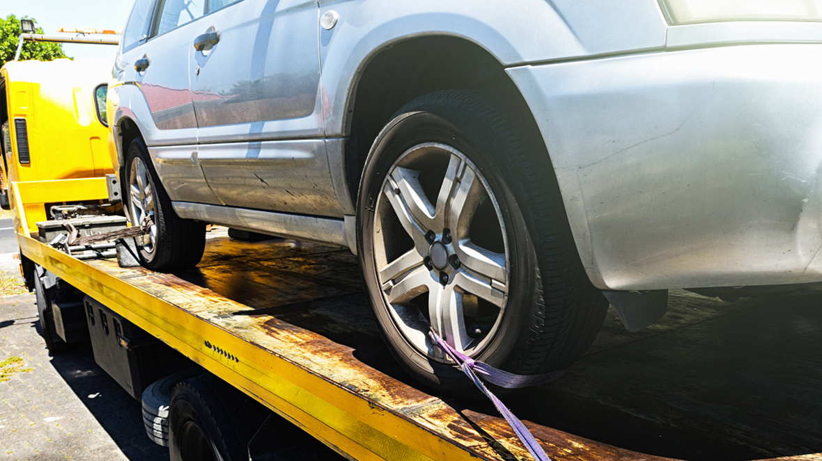 Car being attached to tow truck